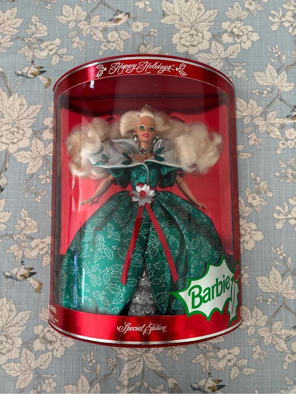 Barbie 1995 special edition holiday doll with green poinsettia dress.